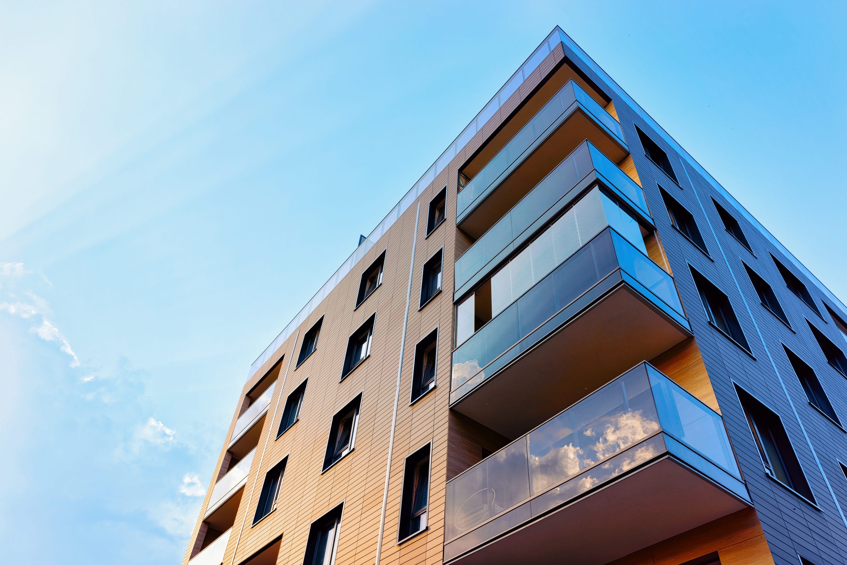 A upward view of an apartment building with patio sections.