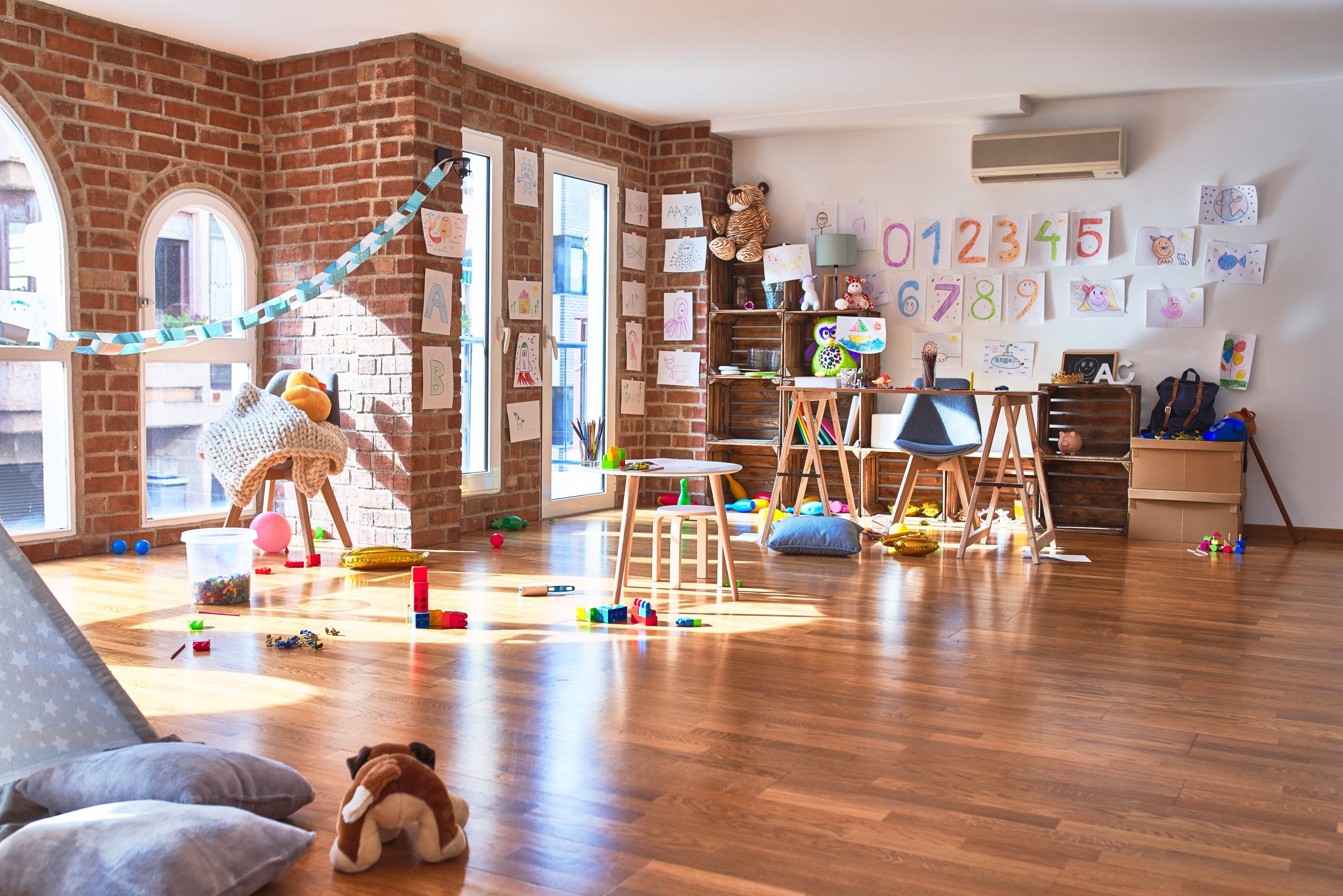 An interior picture of a daycare facility with toys and books.